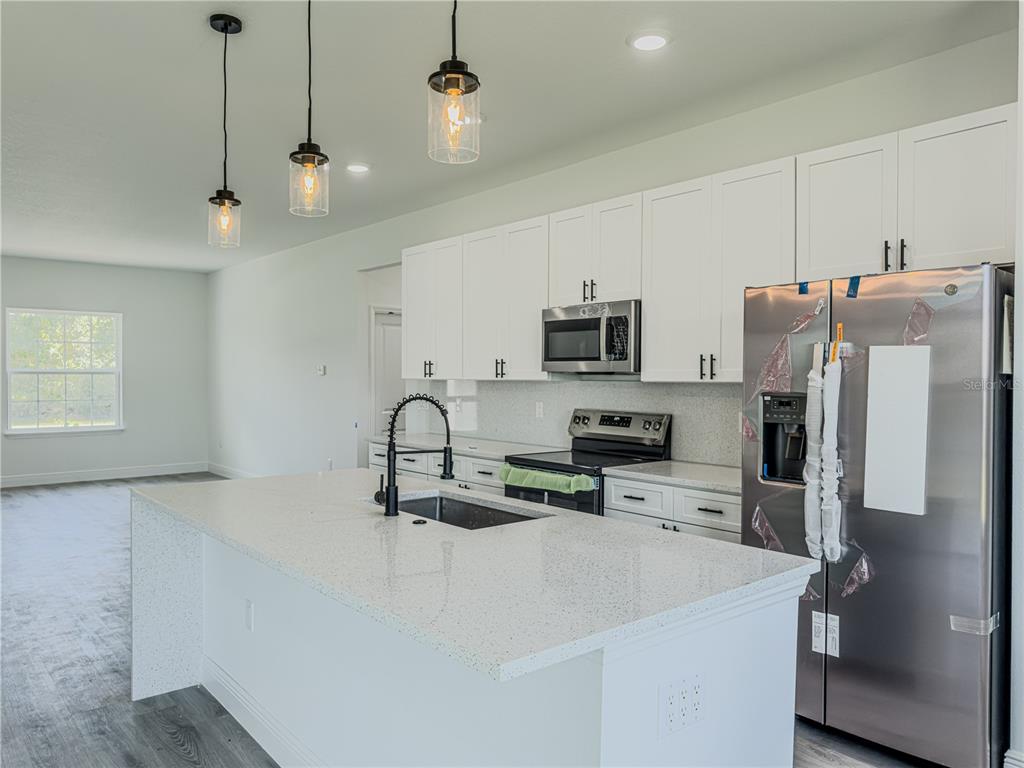 14245 Southwest 28th Court Ocala, FL 34473 - Photo 36 of 85 a kitchen with stainless steel appliances a refrigerator sink and microwave