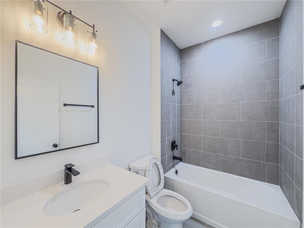 14245 Southwest 28th Court Ocala, FL 34473 - Photo 68 of 85 a bathroom with a sink a toilet and shower