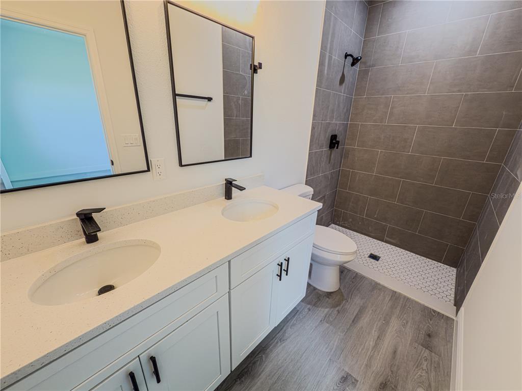 14245 Southwest 28th Court Ocala, FL 34473 - Photo 70 of 85 a bathroom with a sink a toilet and a mirror