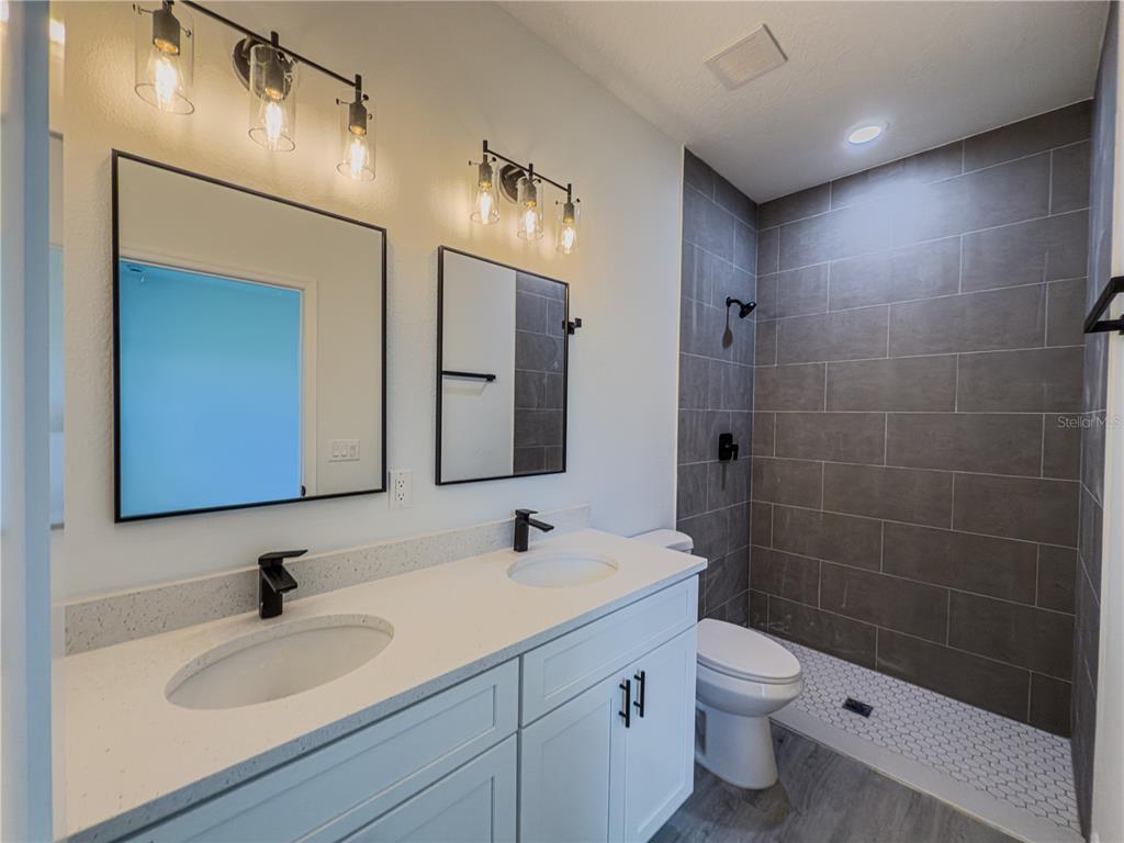 14245 Southwest 28th Court Ocala, FL 34473 - Photo 75 of 85 a bathroom with a sink a toilet and shower