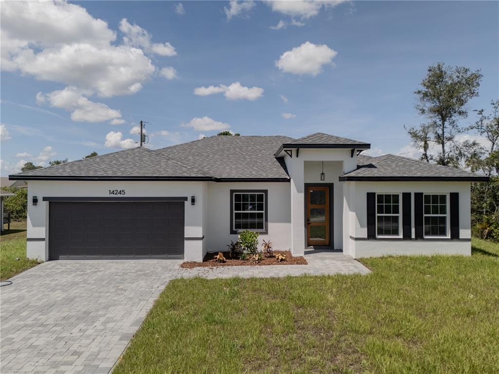 14245 Southwest 28th Court Ocala, FL 34473 - Photo 8 of 85 a front view of a house with a yard and garage