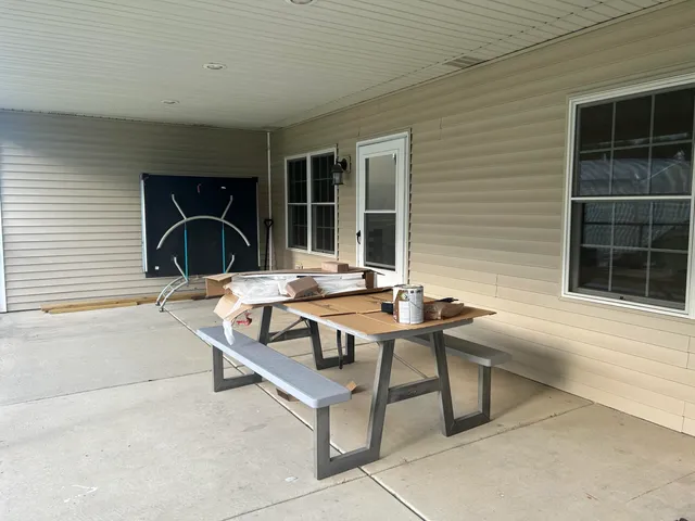 a view of a patio with a table and chairs and potted plants