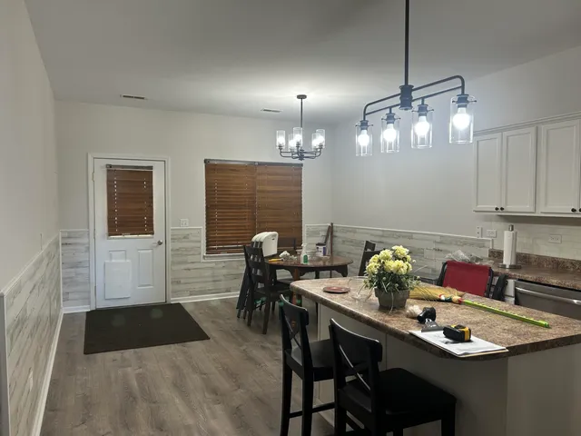 a dining room with furniture and chandelier