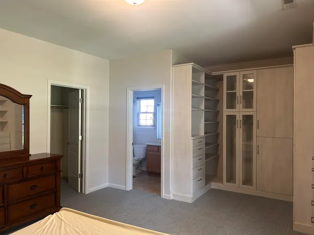 a view of a bedroom with closet and cabinet