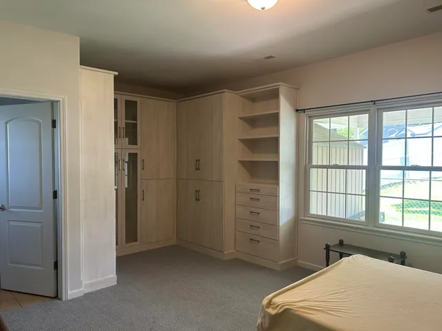 a bedroom with a bed and a window