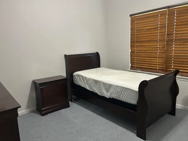 a bedroom with a bed and two lamp