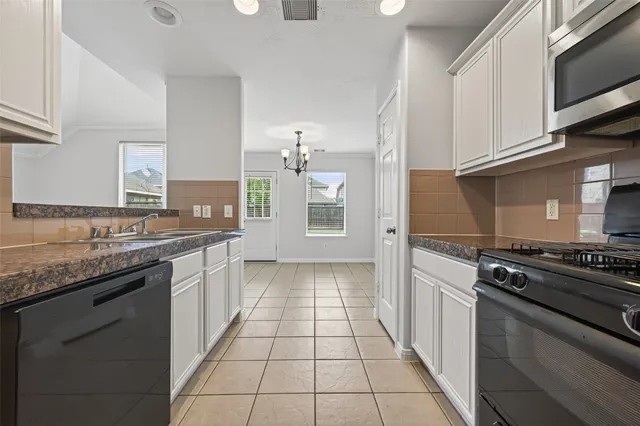 a view of a kitchen with microwave and cabinets