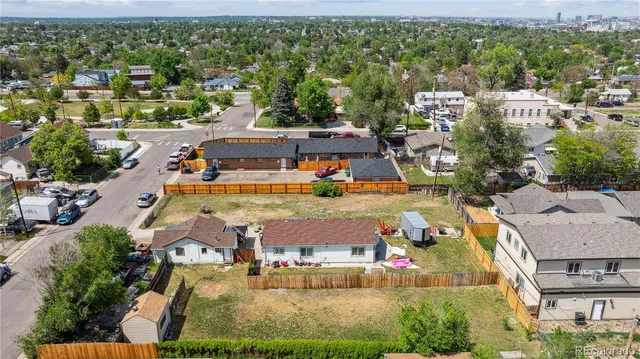 an aerial view of residential houses with outdoor space and parking