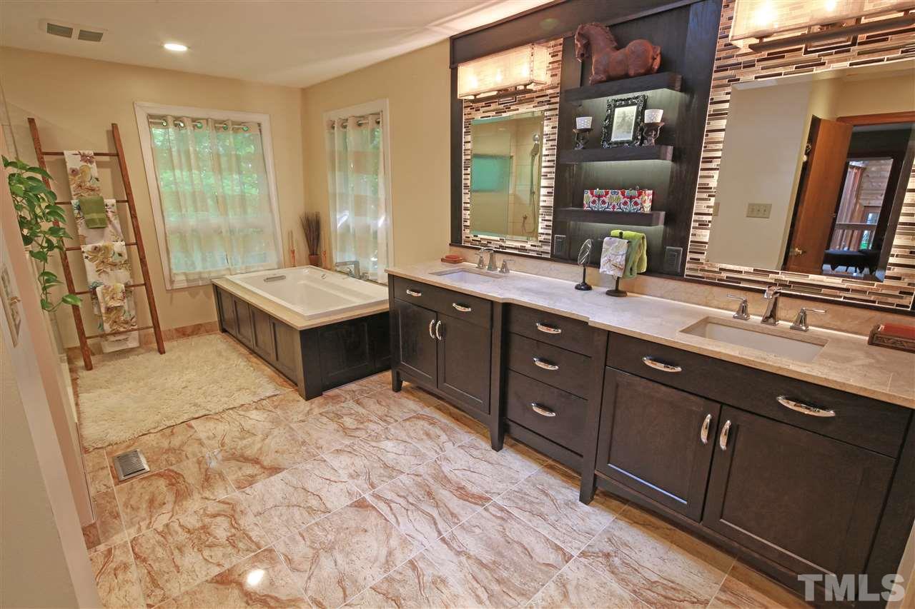 813 Thatcher Way Raleigh, NC 27615 - Photo 14 of 25 a spacious bathroom with a tub sink and mirror