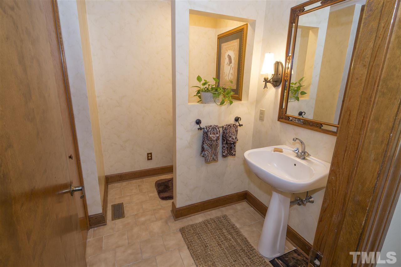 813 Thatcher Way Raleigh, NC 27615 - Photo 21 of 25 a bathroom with a sink toilet and shower