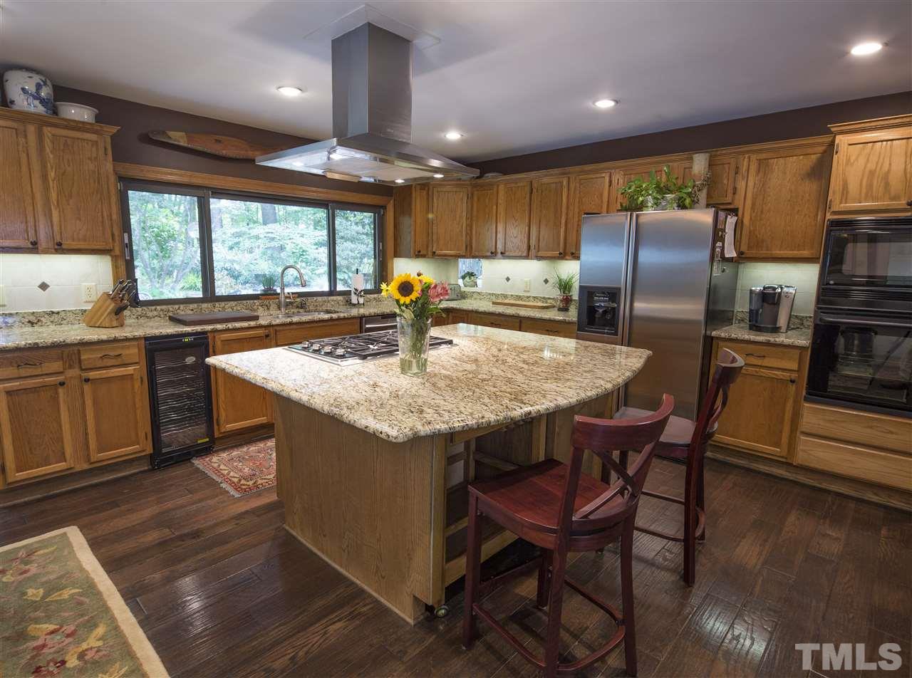 813 Thatcher Way Raleigh, NC 27615 - Photo 9 of 25 a kitchen with stainless steel appliances granite countertop a table chairs sink refrigerator and microwave