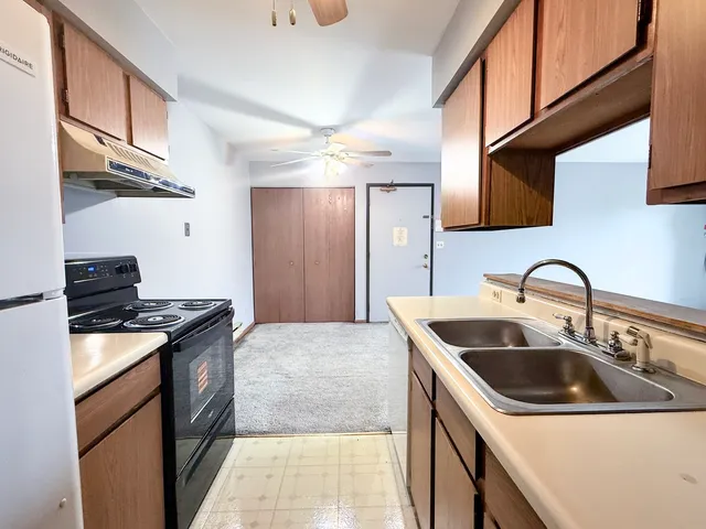a kitchen with stainless steel appliances granite countertop a sink and cabinets