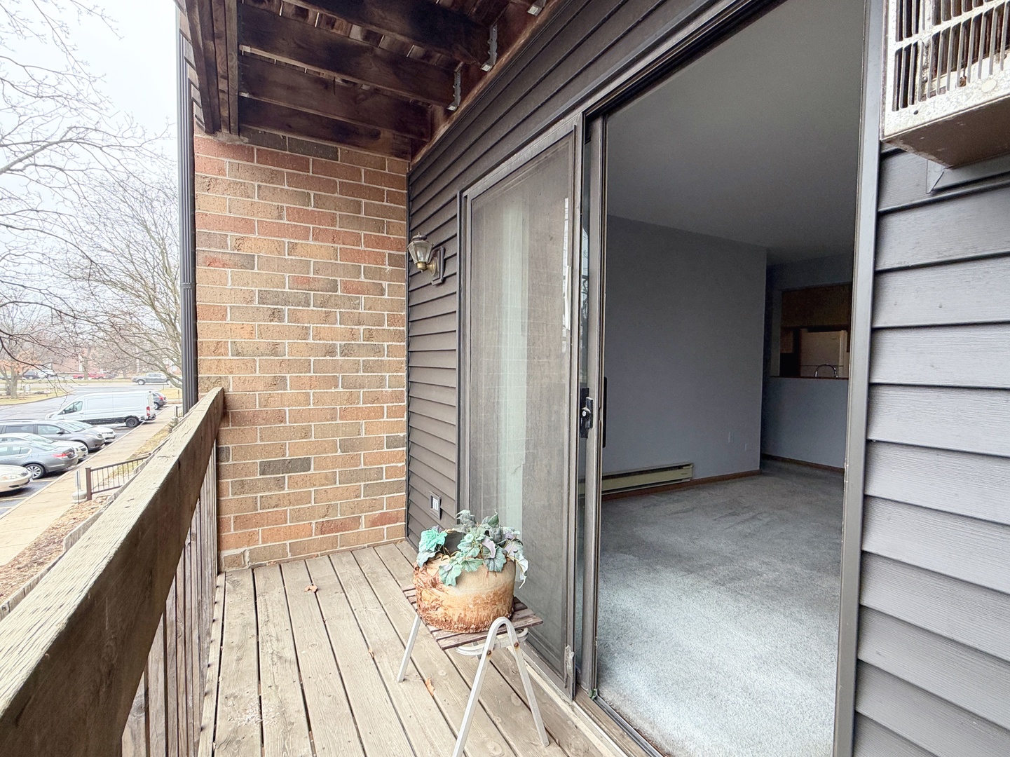 615 South Virginia Road, Unit 204 Crystal Lake, IL 60014 - Photo 7 of 9 a view of a balcony with wooden floor and iron stairs