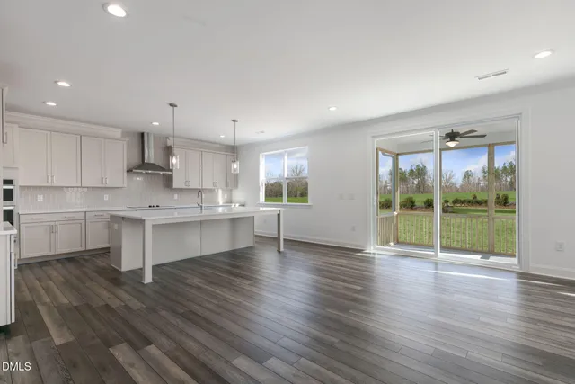 a kitchen with a large window appliances and cabinets