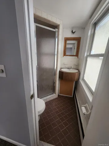 a bathroom with a mirror and a shower