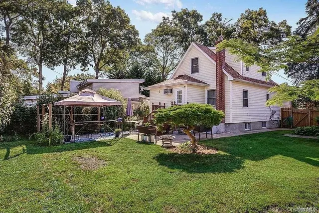 a view of a house with a yard and sitting area