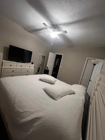 a large white bed in a white room