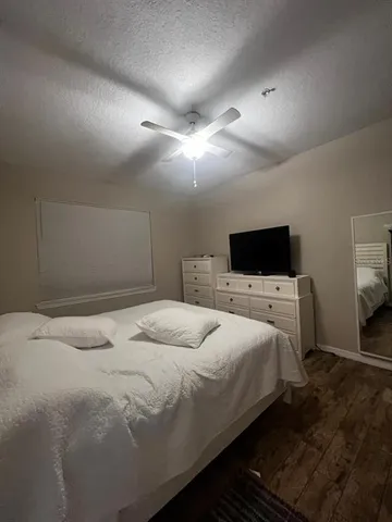 a bedroom with a bed and a flat screen tv