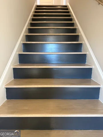 a white toilet sitting in a bathroom next to a sink