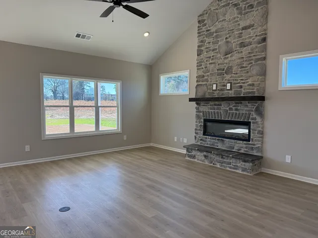 a kitchen with a stove and a wooden floor