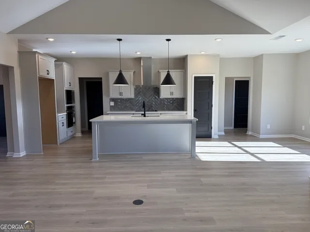 a kitchen with stainless steel appliances white cabinets and a sink