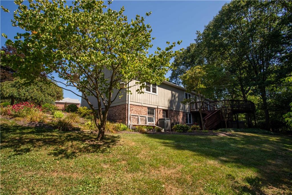 2145 Gypsy Glen Road Beaver, PA 15009 - Photo 39 of 46 a view of a white house next to a yard with big trees