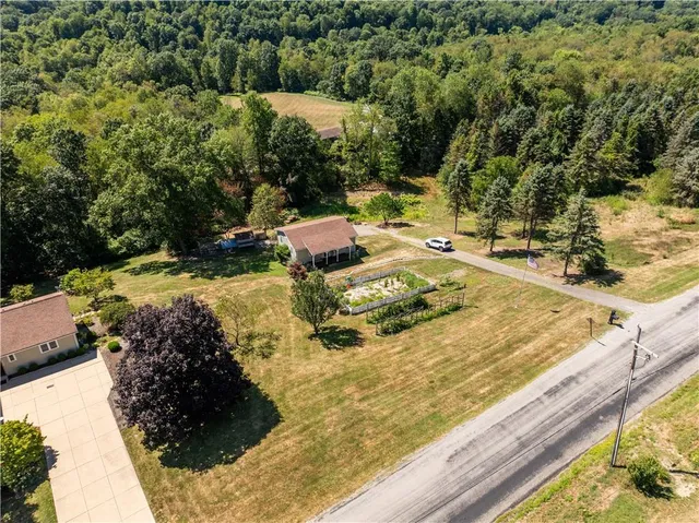 a view of a backyard with table and chairs
