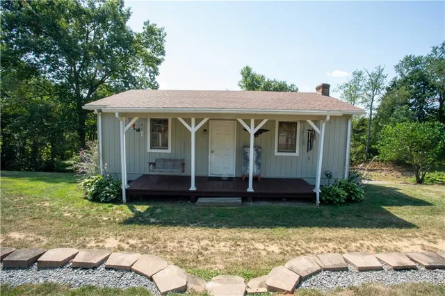 a view of a house with yard and a garden