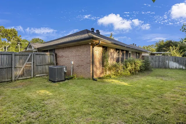 a view of a backyard with plants and a patio