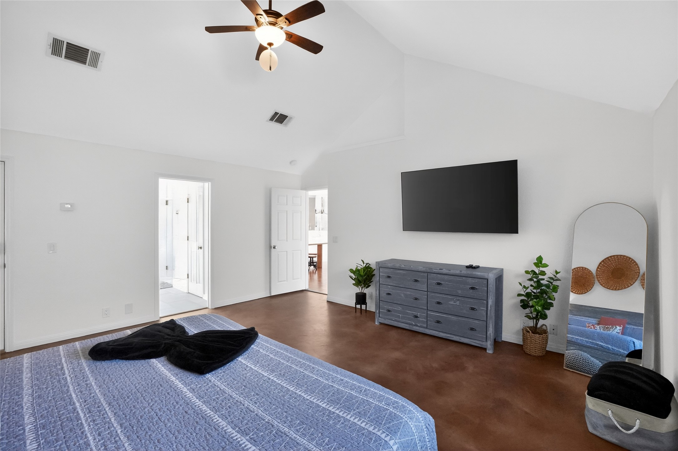 13624 Trautwein Road Austin, TX 78737 - Photo 13 of 38 A tranquil primary bedroom features vaulted ceilings and rich, warm-toned flooring.