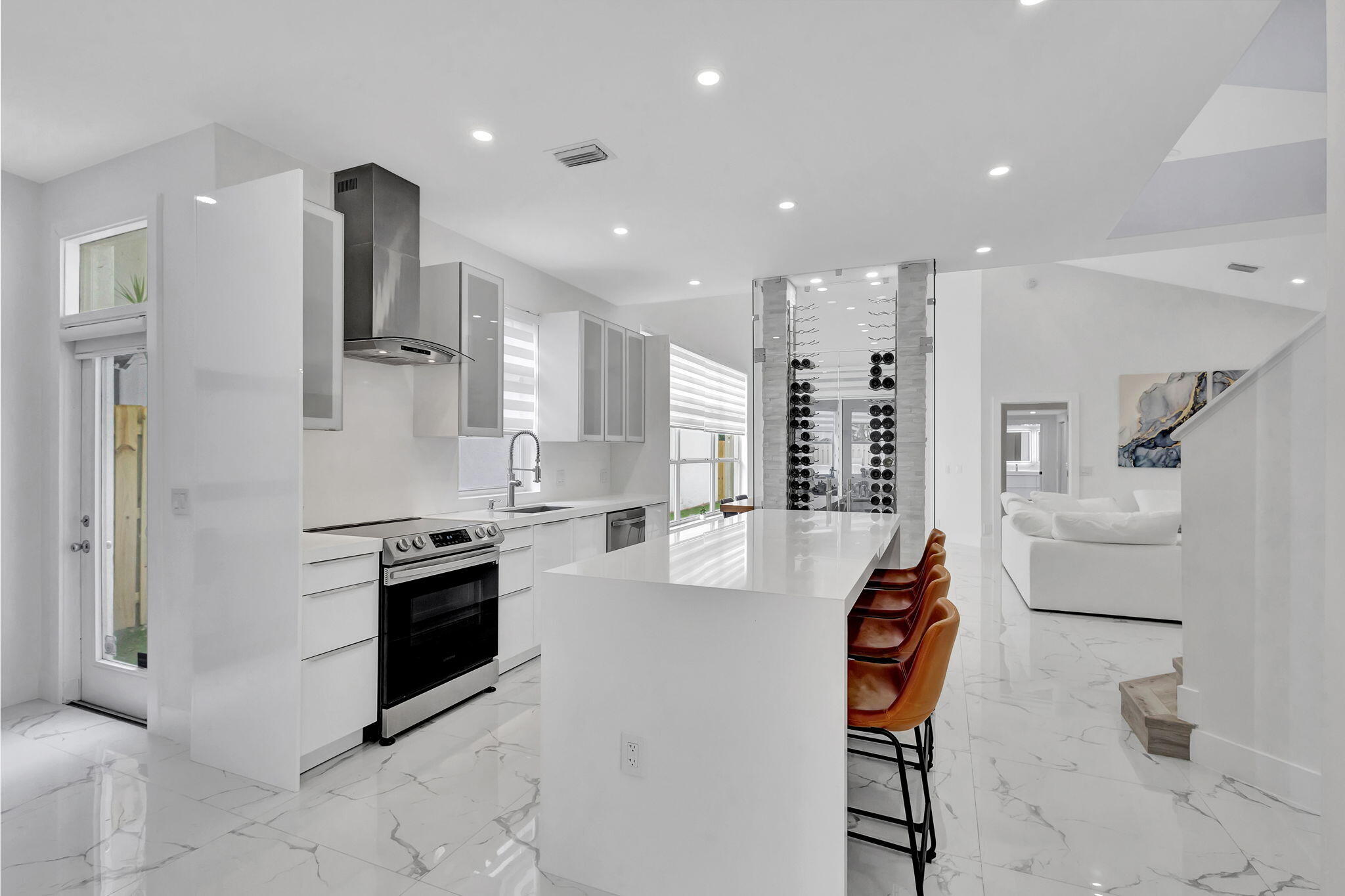 6631 Northwest 25th Avenue Boca Raton, FL 33496 - Photo 14 of 59 a kitchen with stainless steel appliances kitchen island granite countertop a refrigerator and a stove top oven