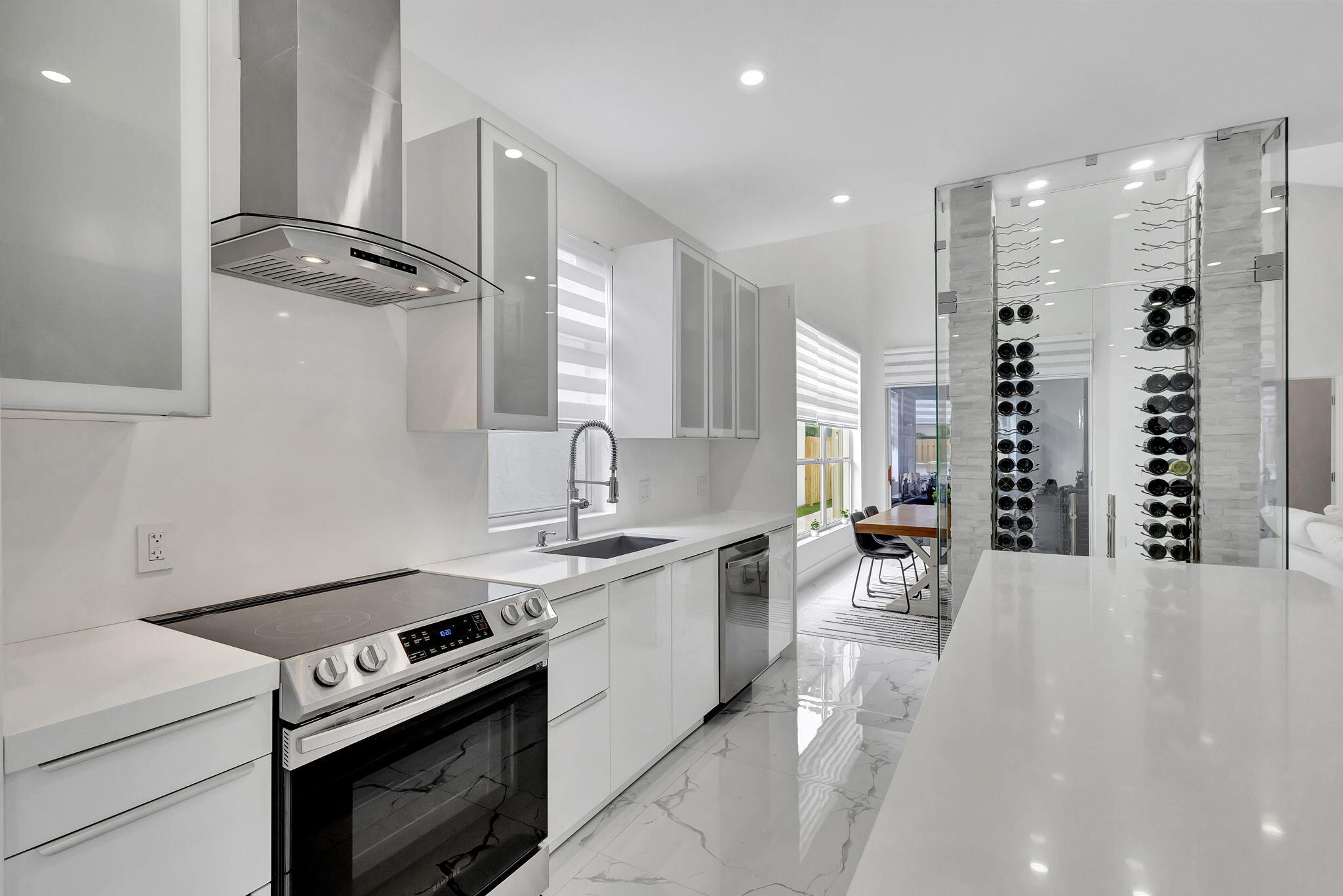 6631 Northwest 25th Avenue Boca Raton, FL 33496 - Photo 18 of 59 a kitchen with a stove and white cabinets