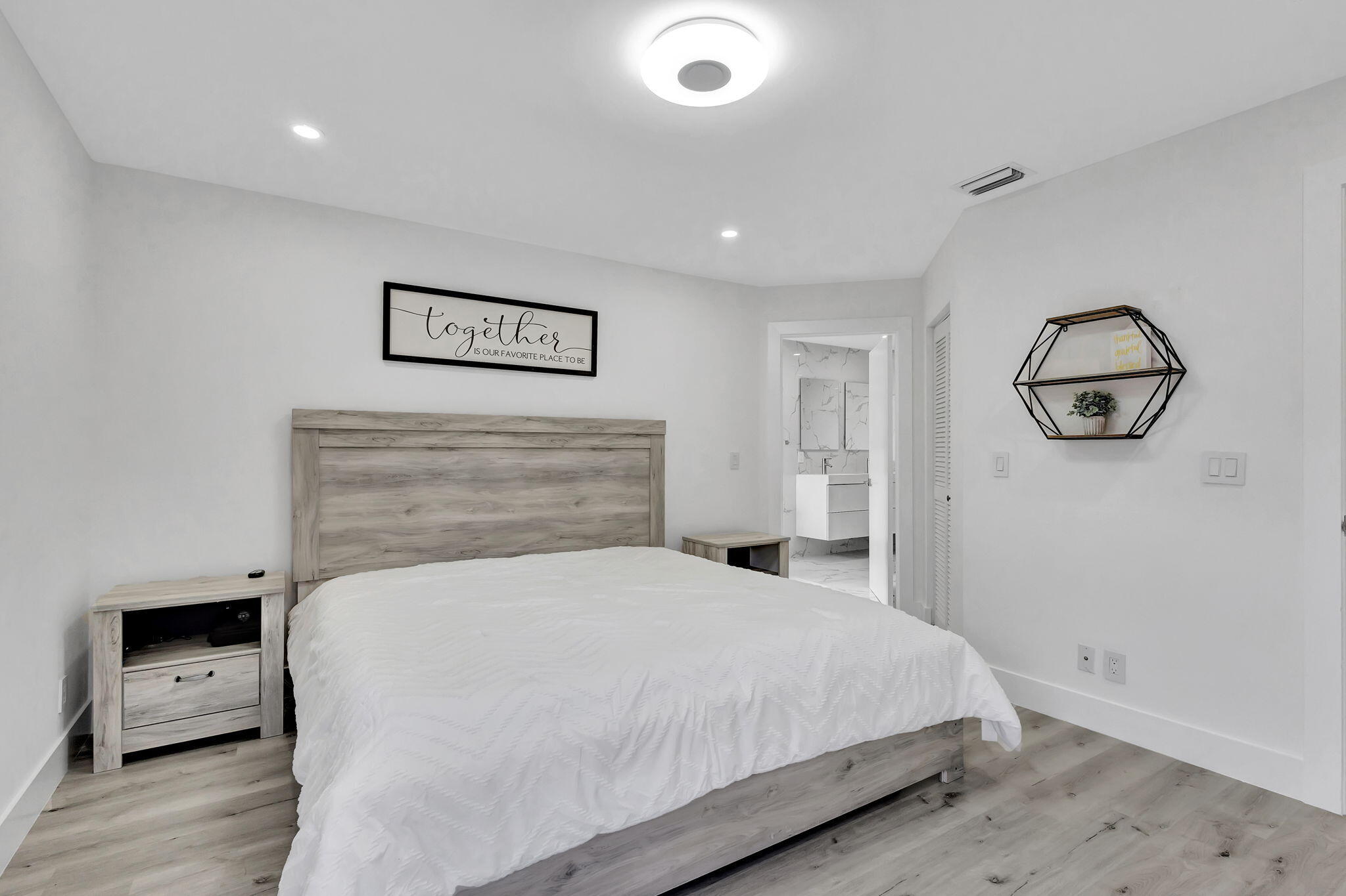 6631 Northwest 25th Avenue Boca Raton, FL 33496 - Photo 30 of 59 a bedroom with a bed and a view of bathroom