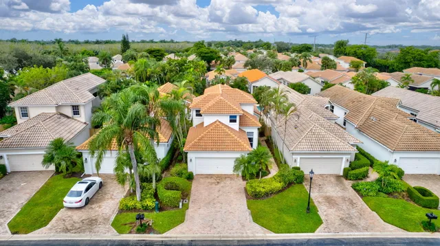 an aerial view of a house with a yard and potted plants