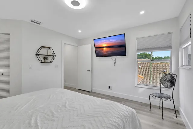 a bathroom with a double vanity sink mirror and toilet