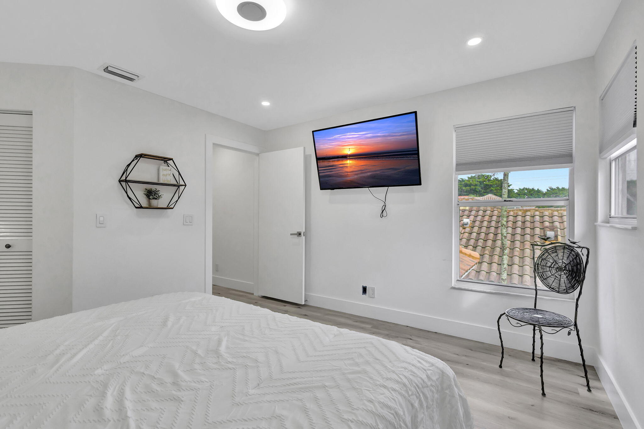 6631 Northwest 25th Avenue Boca Raton, FL 33496 - Photo 31 of 59 a bedroom with a bed and a flat screen tv