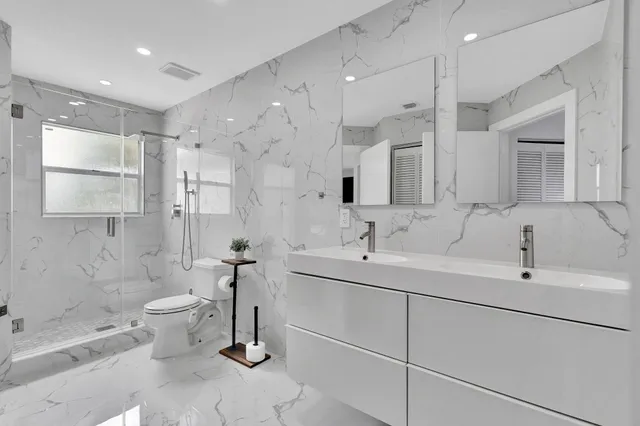 a en suite bathroom with a tub shower and a sink