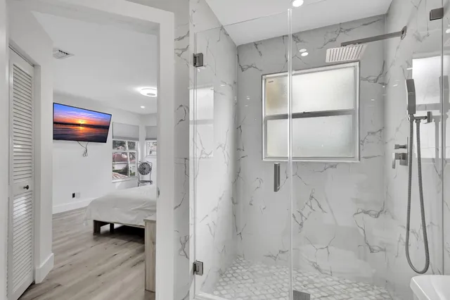 a bedroom with a bed and a flat screen tv