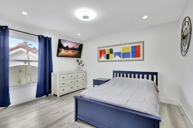 a view of room with window and wooden floor