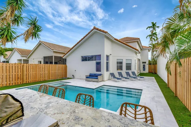 a view of swimming pool with outdoor seating and water view