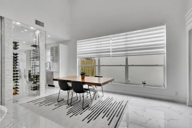 a large kitchen with stainless steel appliances a sink a stove and a refrigerator