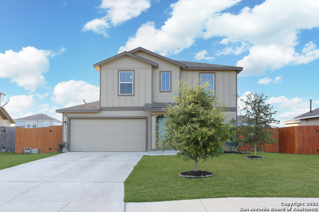 6418 Dynamic Sound San Antonio, TX 78252 - Photo 1 of 1 a front view of a house with a yard and a garage