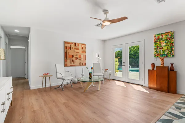 a living room with granite countertop a couch and a dining table with kitchen view