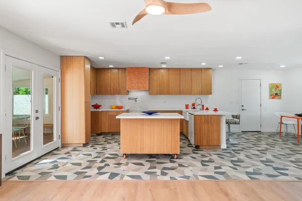 a kitchen with granite countertop cabinets sink and white appliances