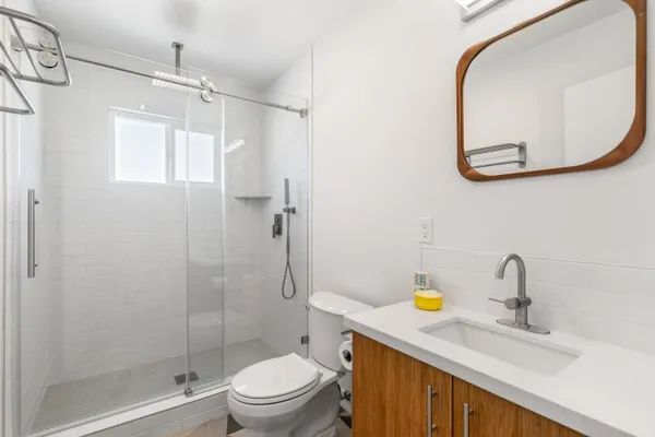 a view of a white house with a swimming pool and sitting area