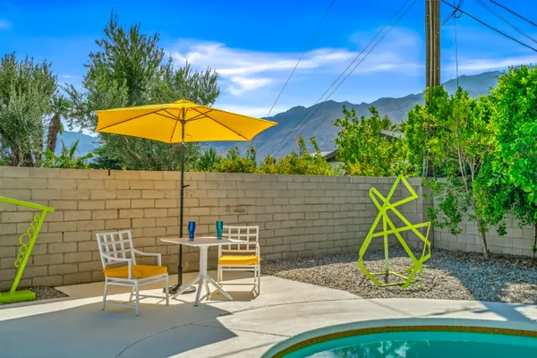 a view of a backyard with a table and chairs