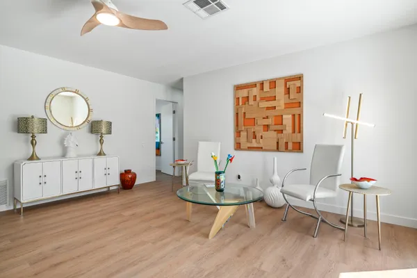 a bedroom with furniture and a wooden floor