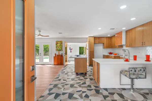 a kitchen with stainless steel appliances granite countertop a refrigerator and a stove top oven
