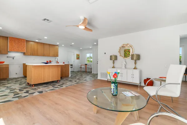 a living room with kitchen island furniture and a table