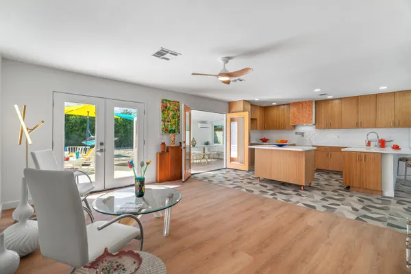 a living room with furniture and wooden floor